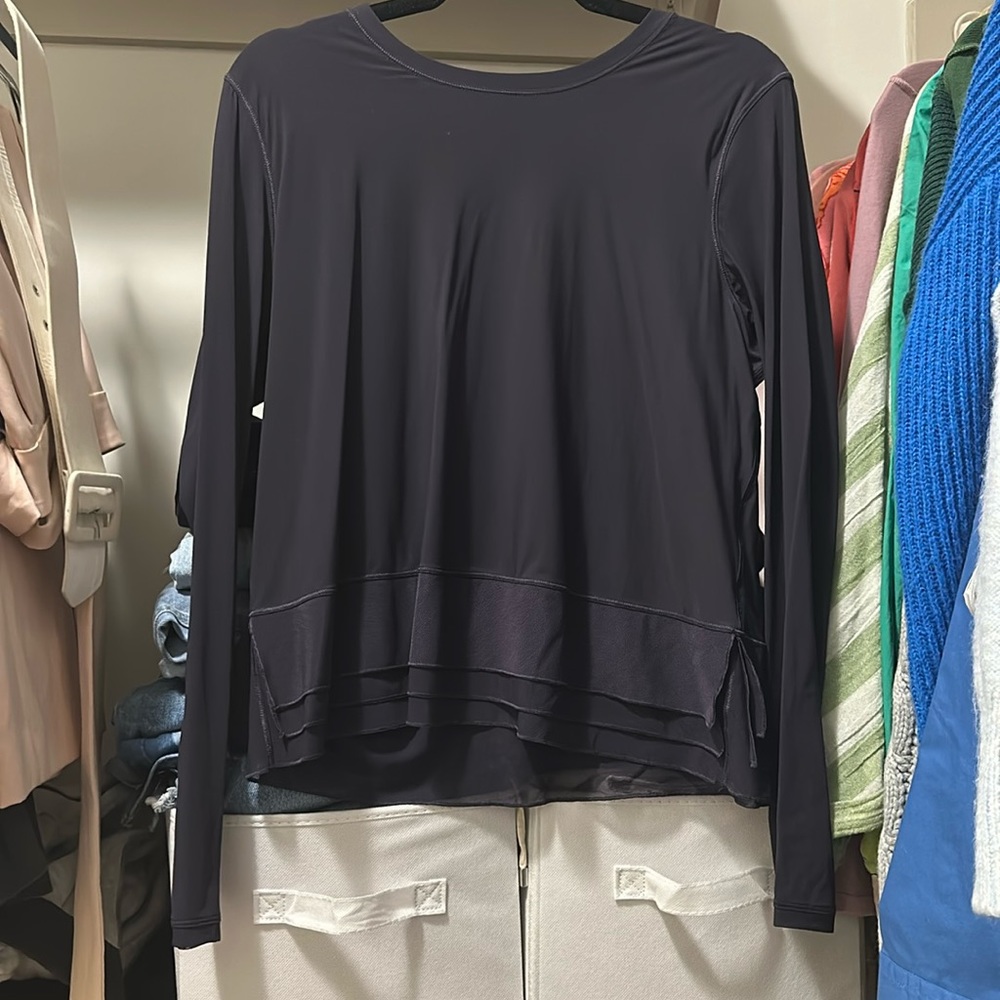 Navy long sleeve lululemon shirt with mesh detail on the bottom